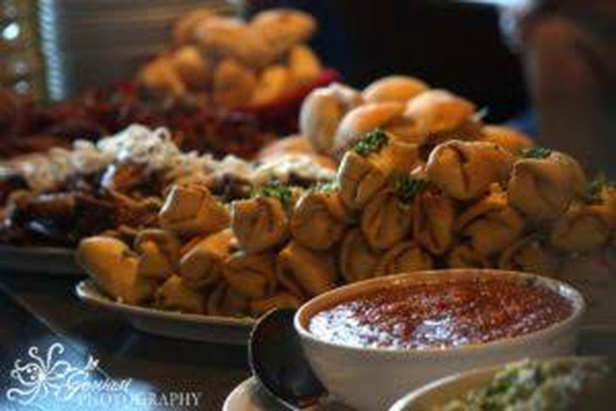 Platters of appetizers and sliders prepared for a private event